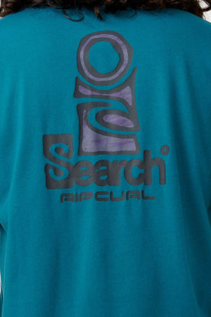 The image features the back of a turquoise Rip Curl Vaporcool Search Stack Tee, highlighted with the word "Search." The design is enhanced by bold, abstract shapes and is made with Vaporcool technology for quick-drying and odor control.