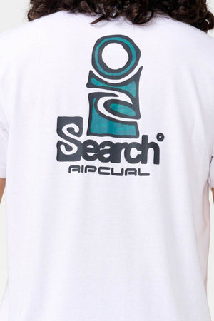 The image displays the back of a Rip Curl Vaporcool Search Stack Tee in white, crafted from moisture-wicking fabric and showcasing a blue and black graphic design with the words "Search" and "Ripcurl." Curly hair is visible at the top of the frame.