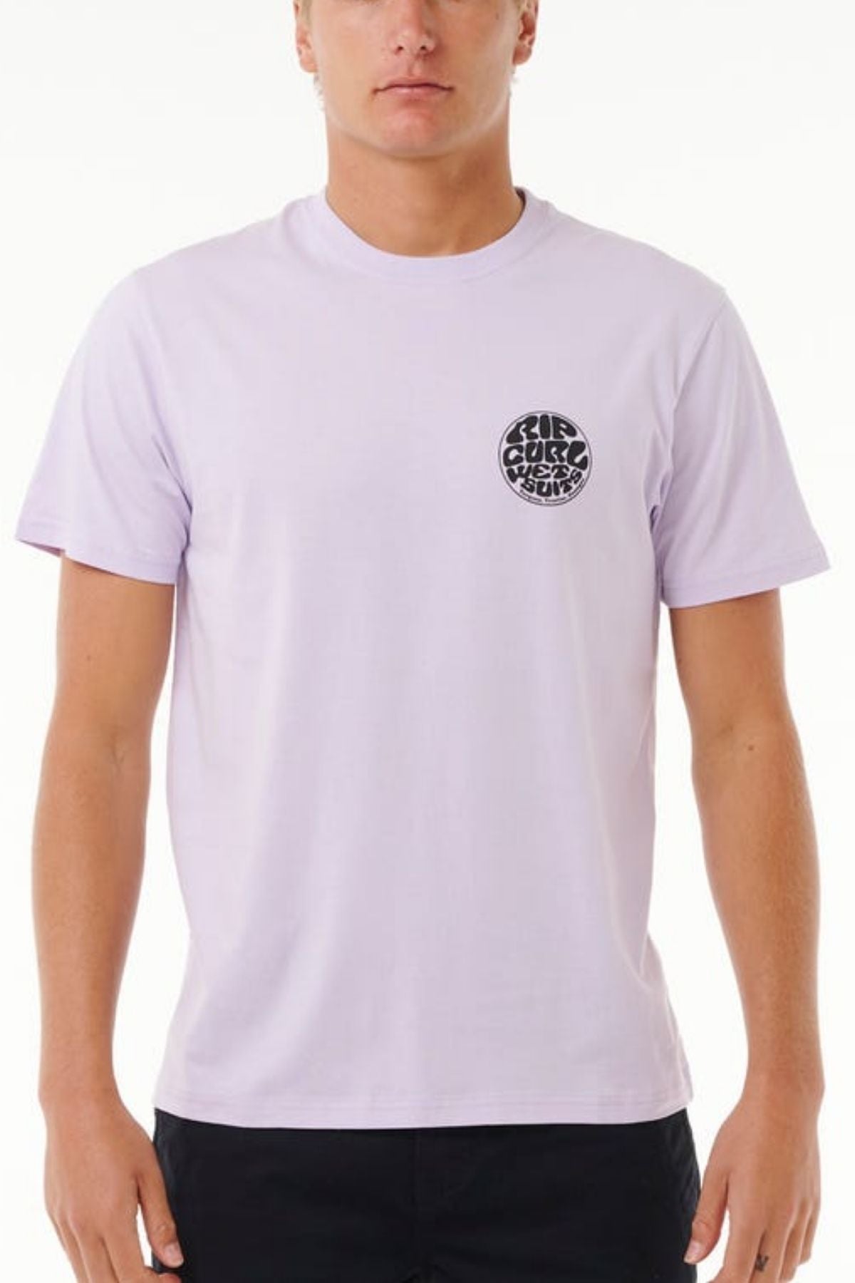 Dressed in a light purple Rip Curl Wetsuit Icon Tee with its logo on the left chest, paired with dark pants and framed by a white backdrop, they are all set for outdoor adventures.