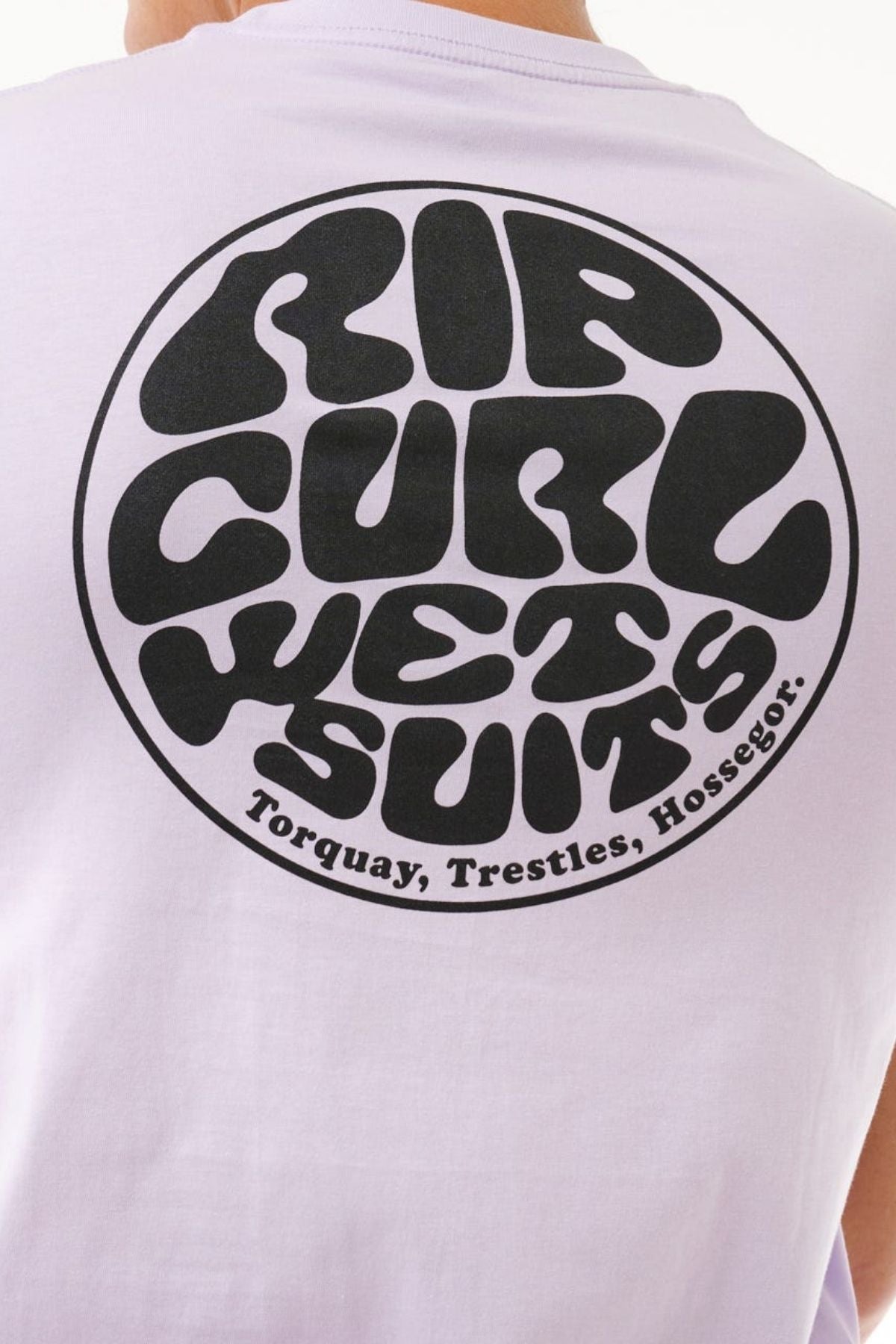 The Rip Curl Wetsuit Icon Tee features a large circular "RIP CURL WETSUITS" logo in bold black on the back, with smaller text below reading "Torquay, Trestles, Hossegor." Made from lightweight cotton, it's ideal for outdoor activities.