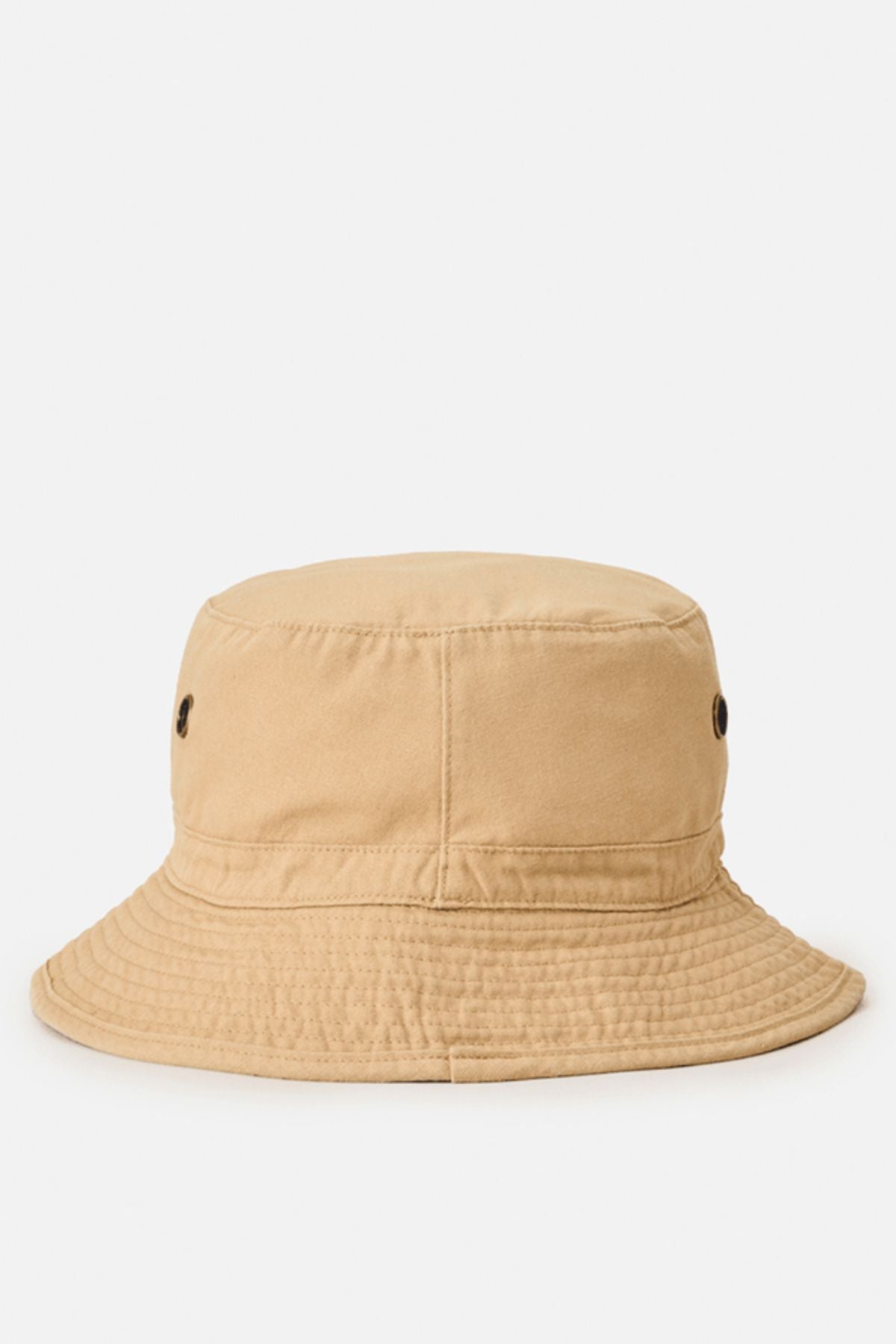 The Rip Curl Wetty Icon Bucket Hat is light brown with fabric construction, stitching details, two black eyelets per side, and a gently downward-sloping brim, shown against a white background.