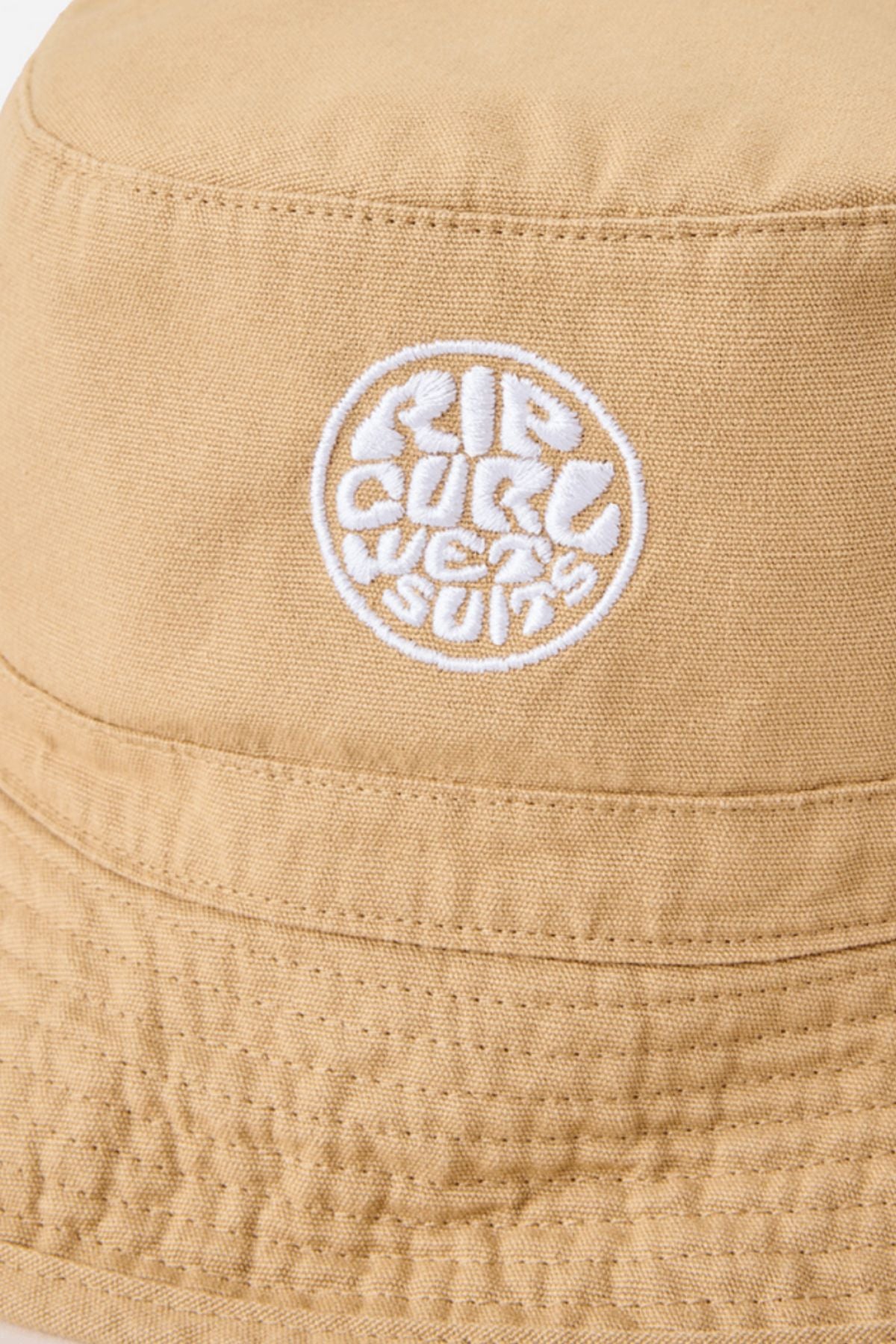 Close-up of the Rip Curl Wetty Icon Bucket Hat, made from organic canvas with a white embroidered "RIP CURL WETSUITS" logo in a circular design on the front.
