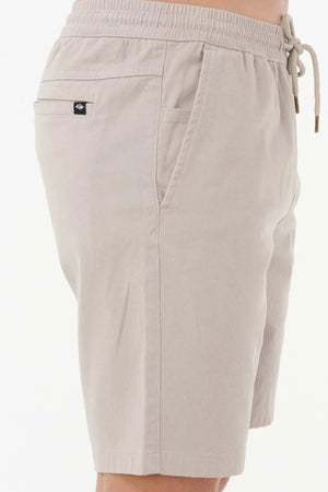 Wearing Rip Curl Classic Surf Volley shorts featuring stretch cotton twill, an adjustable drawcord, side pocket, and a small logo tag above the back pocket against a plain light background.
