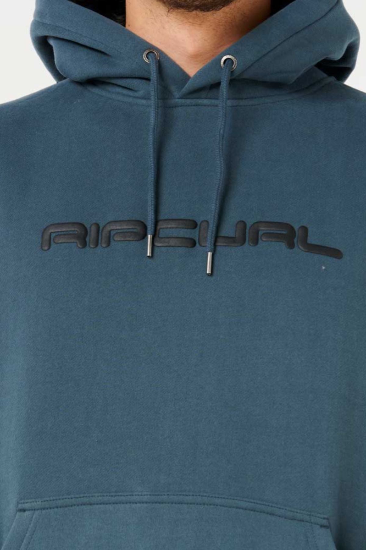 A close-up of a person wearing the Rip Curl Dosed Up Hood, featuring cotton polyester fleece and bold black raised "RIP CURL" lettering across the chest. Only the lower face and upper torso are shown.