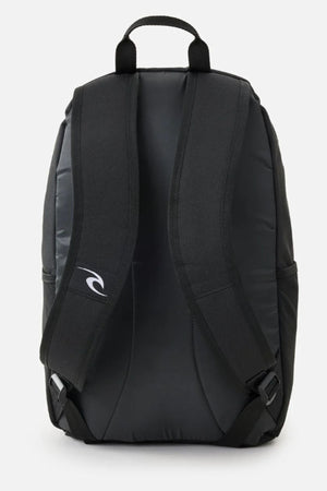 The Rip Curl Ozone Cool 30L Backpack in black is shown from the back, featuring two padded shoulder straps, a top handle, and a white logo. Made with recycled polyester, its sleek design is great for school and has no visible exterior pockets.