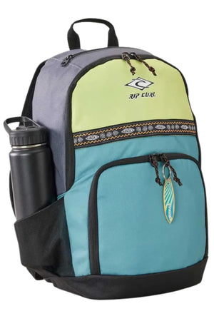 The Rip Curl Ozone Cool 30L Backpack, crafted from recycled polyester with yellow, gray, and turquoise panels, black zippers, tribal-patterned trim, a leaf keychain, and a black water bottle in the side pocket—ideal as a school bag.