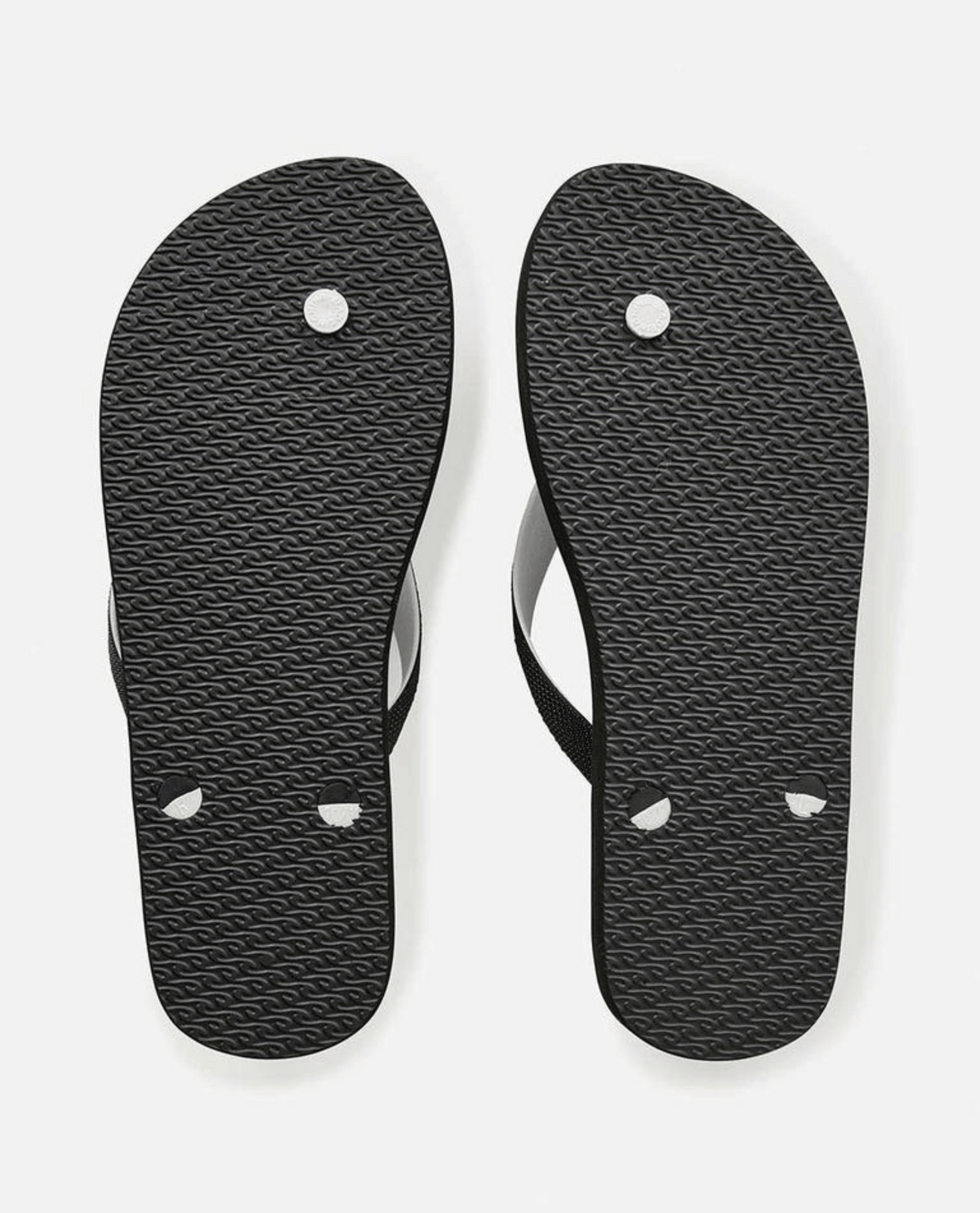 Black Rip Curl Breakers Bloom Thongs crafted from BLOOM algae-blended foam showcasing a textured sole and visible thong attachment points against a crisp white background, as part of Rip Curl's eco-friendly fashion collection.