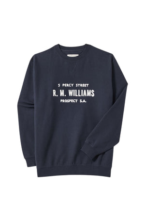 The RM Williams Bale Loopback Sweatshirt is a relaxed-fit navy crewneck featuring "5 Percy Street R.M. Williams Prospect S.A." in white text across the chest.