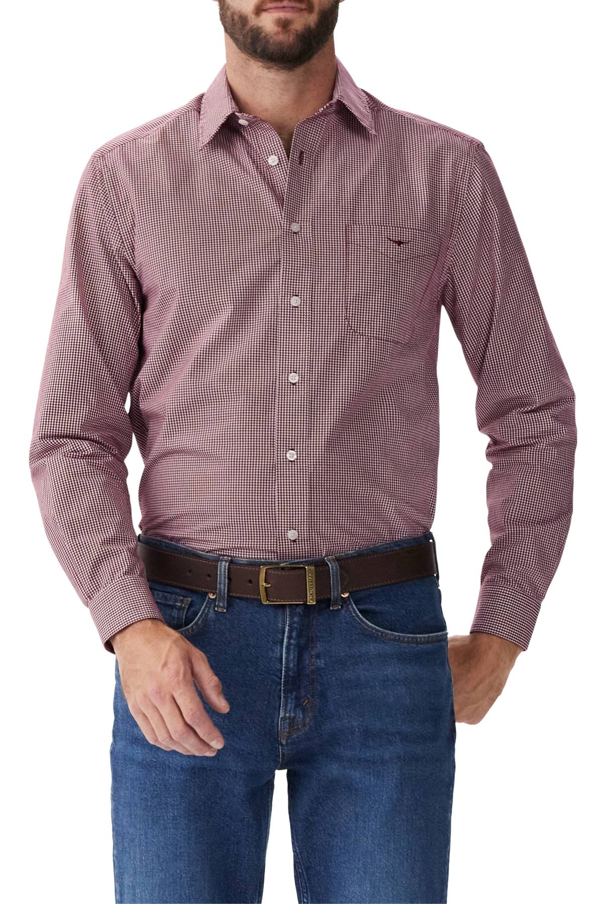 A man wearing an RM Williams Classic Shirt tucked into blue jeans with a brown belt, standing against a plain white background.