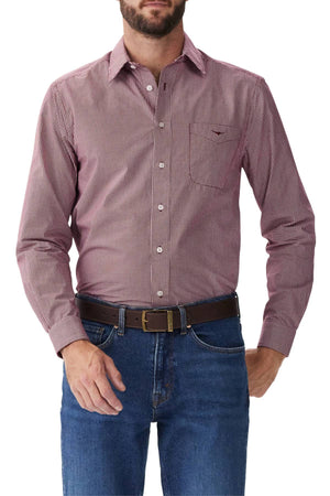 A man wearing an RM Williams Classic Shirt tucked into blue jeans with a brown belt, standing against a plain white background.