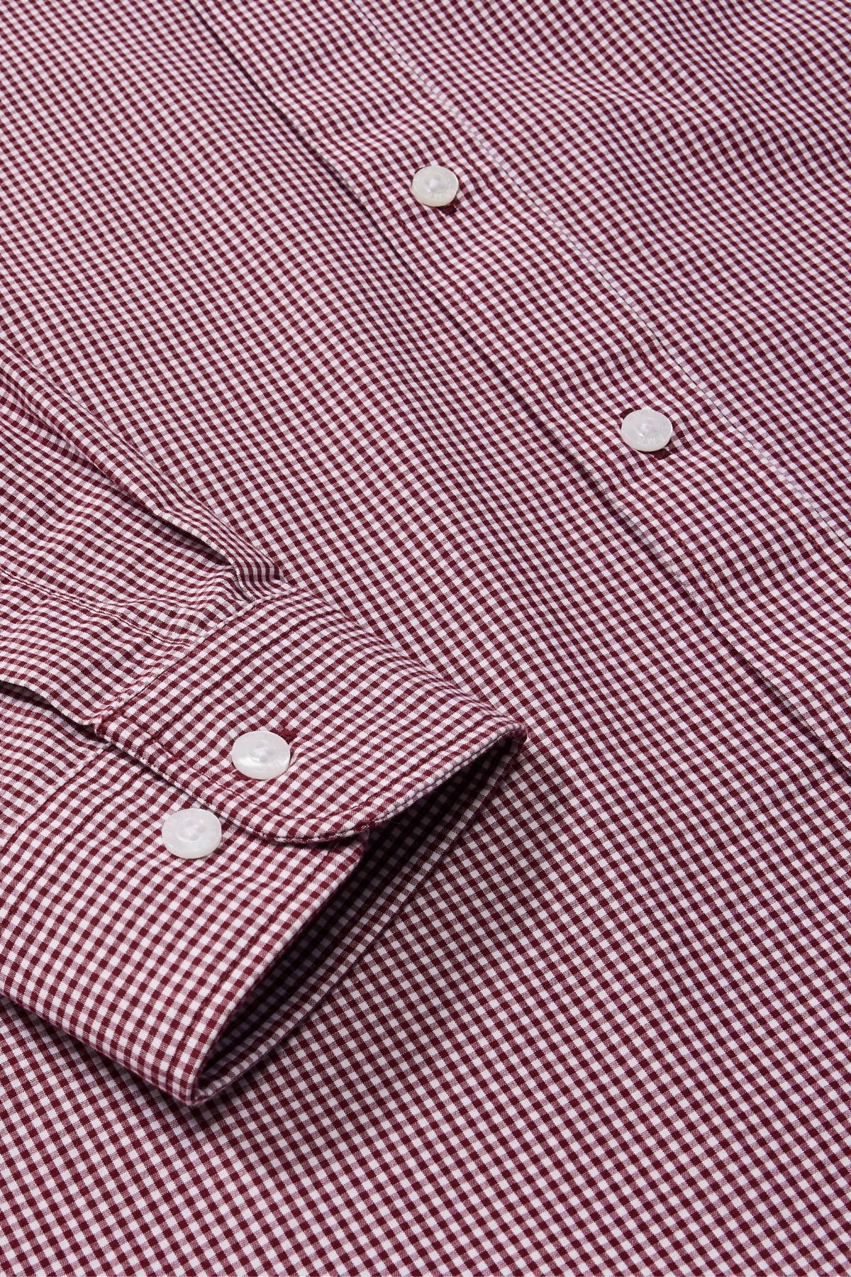 Close-up of the RM Williams Classic Shirt in maroon and white micro gingham, featuring white buttons, sleeve cuff, and front. The classic small, uniform gingham pattern gives a timeless look.