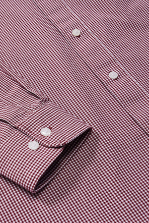 Close-up of the RM Williams Classic Shirt in maroon and white micro gingham, featuring white buttons, sleeve cuff, and front. The classic small, uniform gingham pattern gives a timeless look.