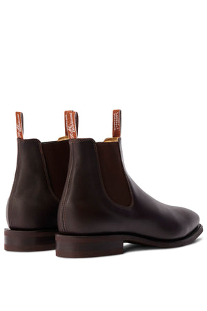 The RM Williams Comfort Craftsman Boot, a handcrafted leather Chelsea boot with elastic sides, pull tabs, and stacked wooden heels, is shown diagonally with the heels facing forward.