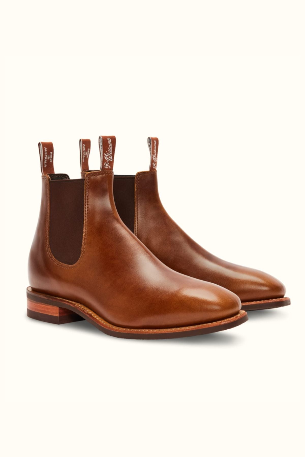 The RM Williams Comfort Craftsman Boot is a brown pull-up leather Chelsea boot with elastic side panels, rear pull tabs, and a rubber sole, shown against a plain light background.