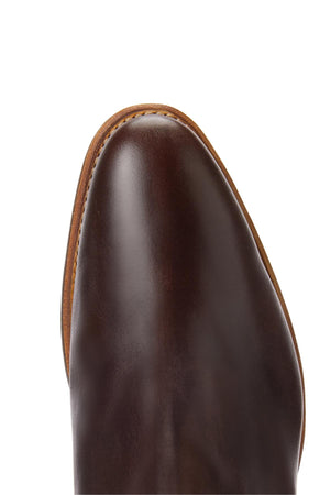 Close-up of the toe of the RM Williams Comfort Lady Yearling Rubber Sole Boot in polished brown leather with a tan welt, crafted using Goodyear welt construction, shown against a white background.