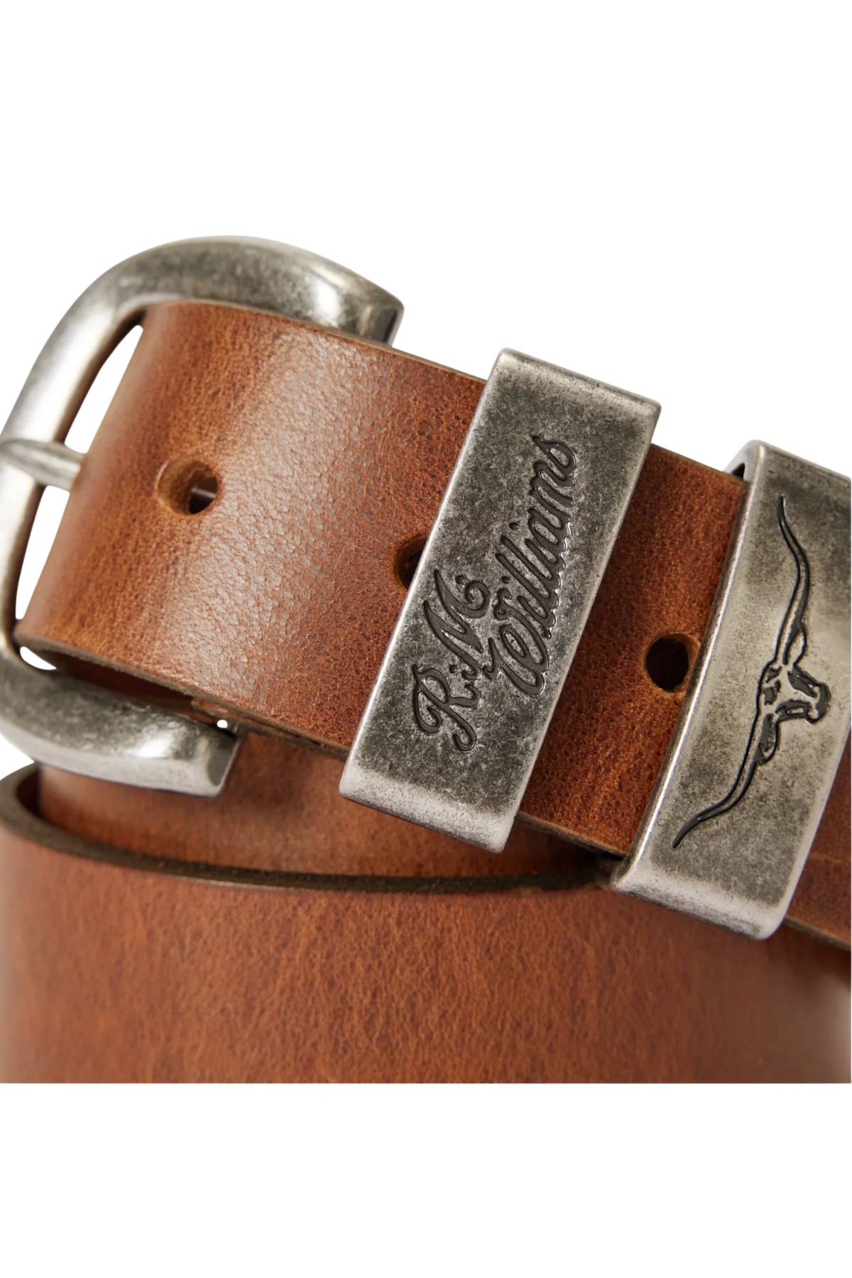 Close-up of the RM Williams Drover Belt, crafted in brown premium leather with an antique silver buckle and two engraved metal loops—one with "R.M. Williams" script, the other featuring a longhorn logo.