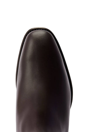 Close-up of the toe area of a dark brown RM Williams Dynamic Flex Craftsman Boot, featuring smooth, polished yearling leather and a rounded, slightly squared shape on a white background.
