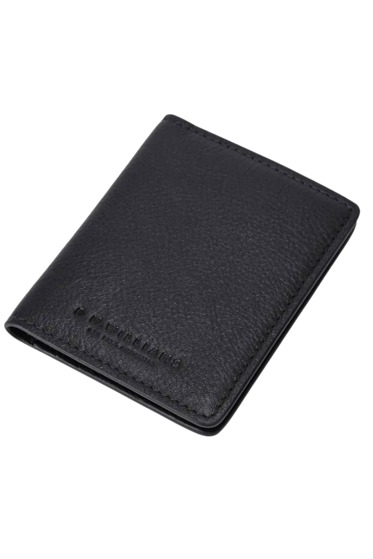 The RM Williams Farrier Fold Cardholder is shown closed and angled on a white background. It features black full-grain textured leather with a subtly embossed R.M.Williams logo in the lower corner.