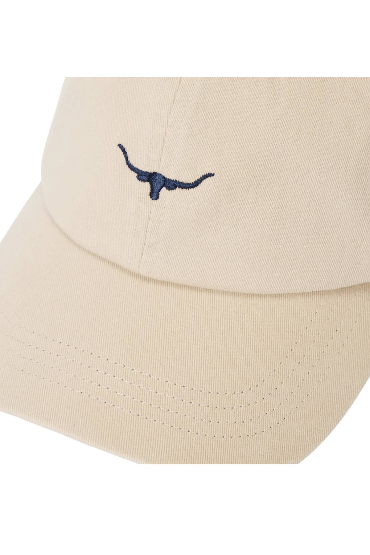 Close-up of the RM Williams Mini Longhorn Twill Cap in beige organic cotton, featuring an embroidered mini Longhorn logo on the front and an adjustable back strap.