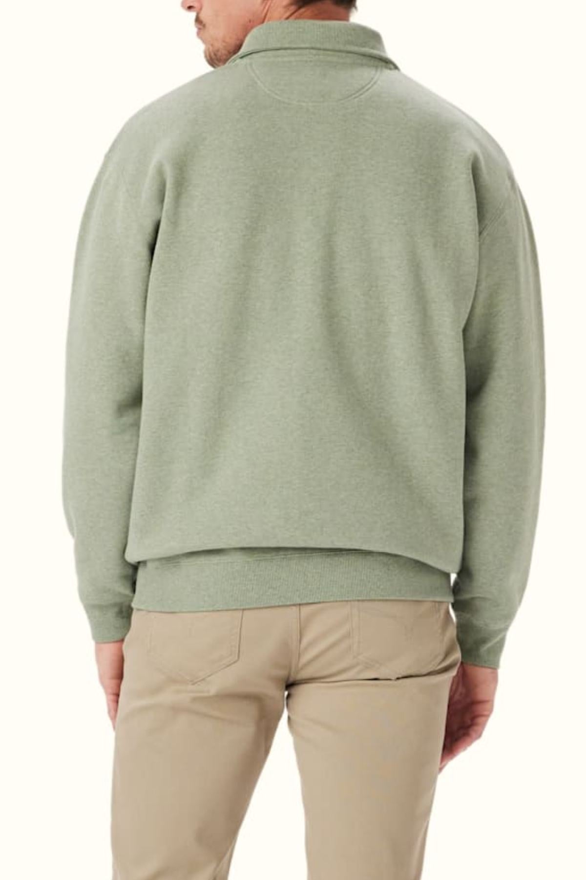 A man is shown from the back wearing an RM Williams Mulyungarie Fleece in light green and beige pants against a plain, light background.