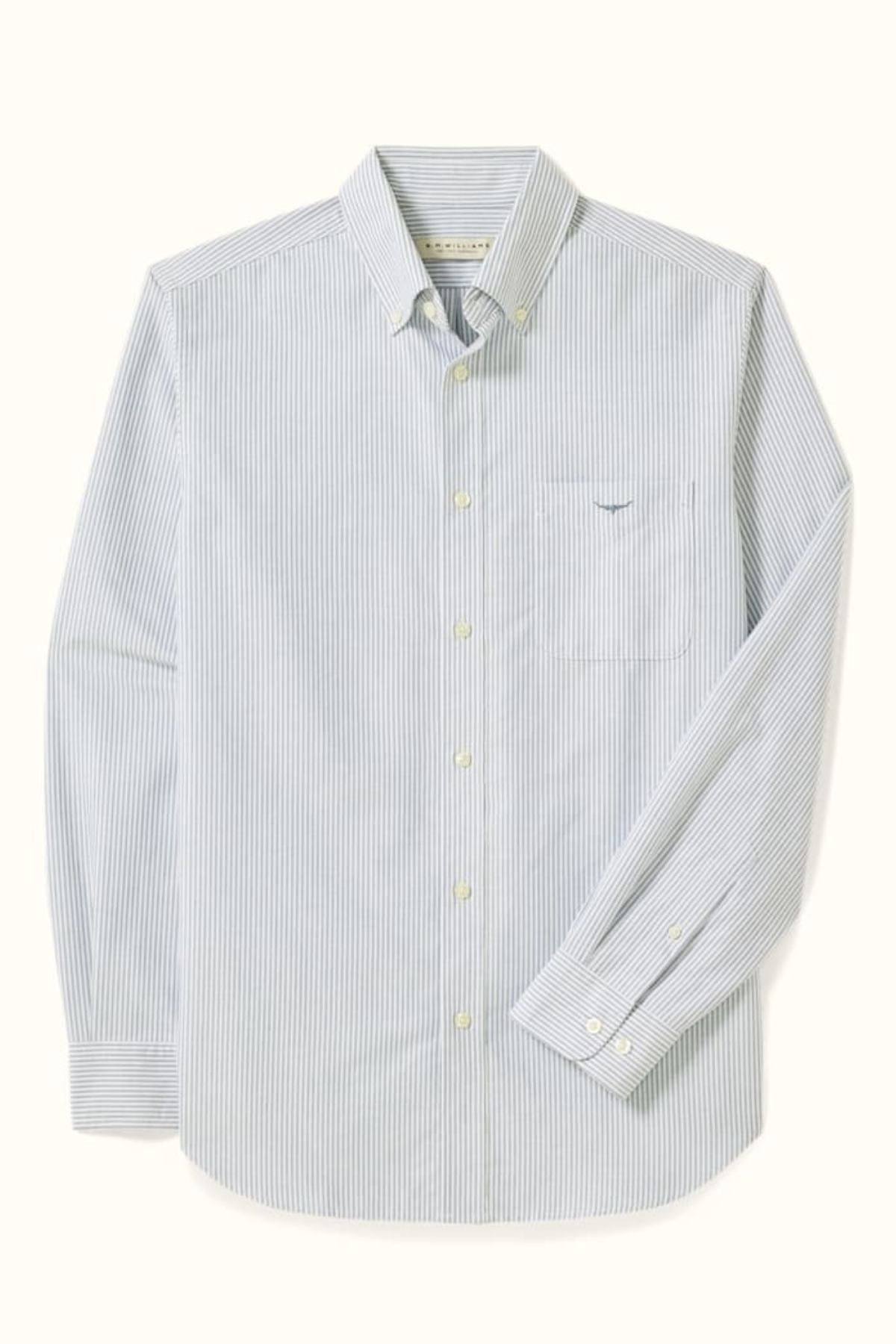 The RM Williams Regular Oxford Stripe Shirt in light blue and white pinstripes is made from organic cotton, featuring a button-down collar, chest pocket, and buttoned cuffs, displayed on a light background.