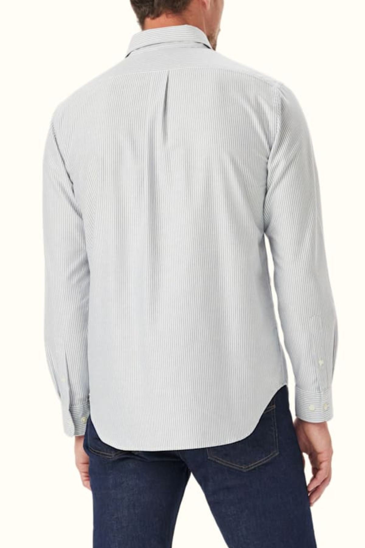 A man is shown from the back wearing the RM Williams Regular Oxford Stripe Shirt in light blue and white stripes with a button-down collar, paired with dark blue jeans, against a plain light background.
