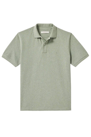 The RM Williams Rod Polo is a light sage green, short-sleeve polo shirt with a collar and two buttons, made from organic cotton and shown laid flat on a white background.