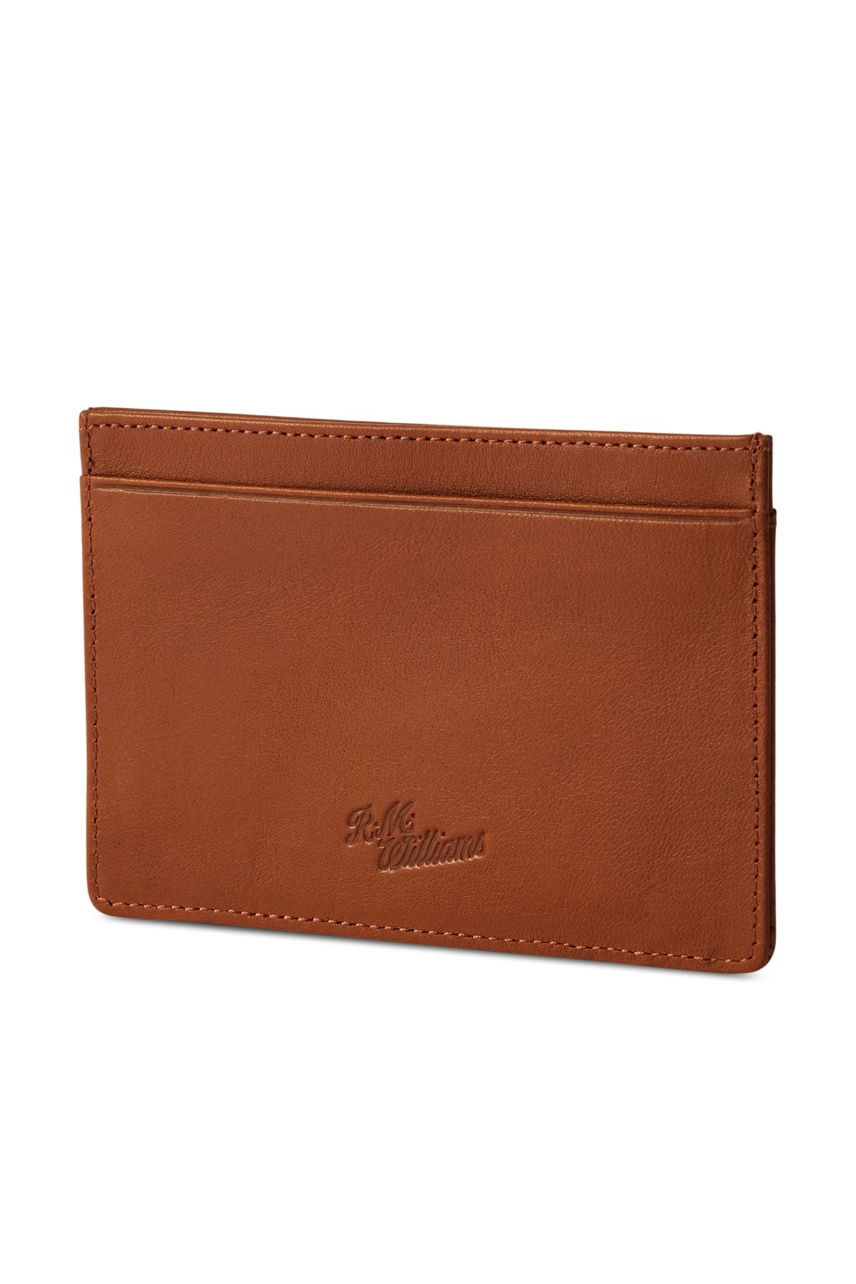 The RM Williams Singleton Vertical Card Holder, handmade in Australia from brown leather, features a single slot and embossed text at the bottom center. It boasts a smooth texture with visible stitching around the edges.