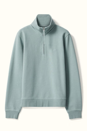The RM Williams Trickett Zip Neck Sweatshirt is a light blue-green quarter-zip in organic cotton, with a stand collar, long sleeves, ribbed cuffs and hem, and a subtle chest logo.