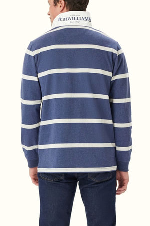 Seen from the back, a person wears jeans and the RM Williams Tweedale Rugby—a blue heavyweight cotton shirt with white horizontal stripes and a collar that features "Australia R.M. Williams Est. 1932" in navy blue.