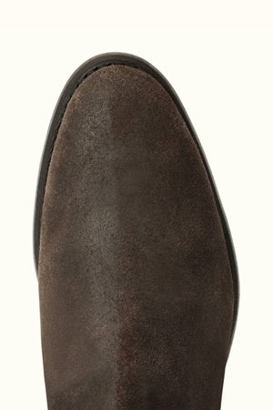 Close-up of the toe on an RM Williams Comfort Lady Yearling Boot in brown waxed suede, featuring a rounded shape and black sole trim, photographed against a light background.