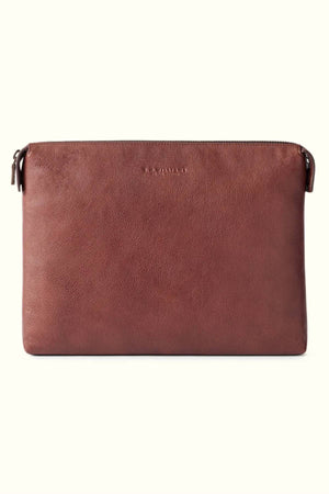 The RM Williams Farrier Tech Case is a brown tumbled grain leather zippered pouch with a smooth, textured surface and "RM Williams" subtly embossed near the top—ideal for storing your tech essentials. Shown against an off-white background.