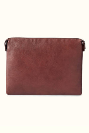 The RM Williams Farrier Tech Case is a rectangular brown pouch made from tumbled grain leather with a smooth texture and water-resistant lining, shown against an off-white background.