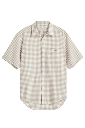 The RM Williams Johnson Check Short Sleeve Shirt features a beige and white gingham check pattern, a button-up front, short sleeves, a left chest pocket, and a slightly curved hem.