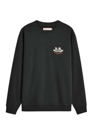 RM Williams Kandos Crew is a black crewneck sweatshirt with long sleeves, featuring a small “R.M. Williams USA” logo in white and red printed on the upper left chest. This sweatshirt boasts a simple and casual design.
