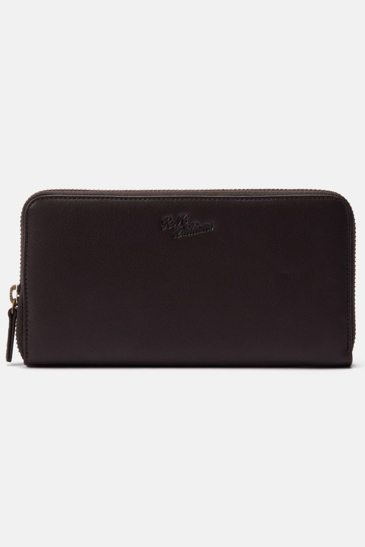 The RM Williams Singleton Zip Wallet is a black full-grain leather zip-around wallet with subtle front embossed branding, a gold zipper pull, and ample internal storage. It is showcased against a plain white background.