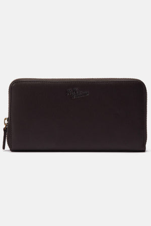 The RM Williams Singleton Zip Wallet is a black full-grain leather zip-around wallet with subtle front embossed branding, a gold zipper pull, and ample internal storage. It is showcased against a plain white background.