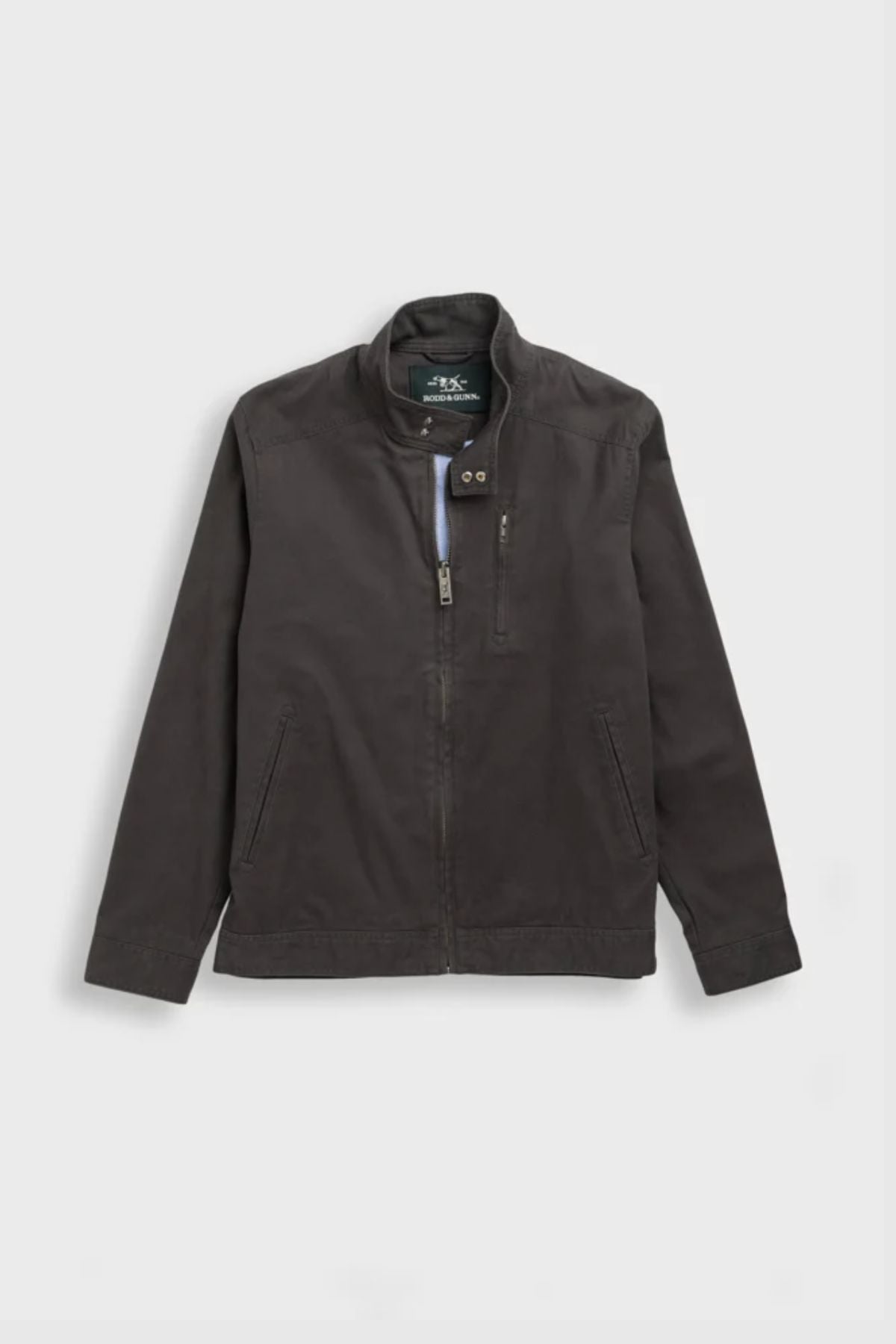 The Rodd & Gunn Armitage Jacket, in dark gray with long sleeves, a stand collar, YKK front zipper, and zippered chest pocket, is displayed on a light gray background.