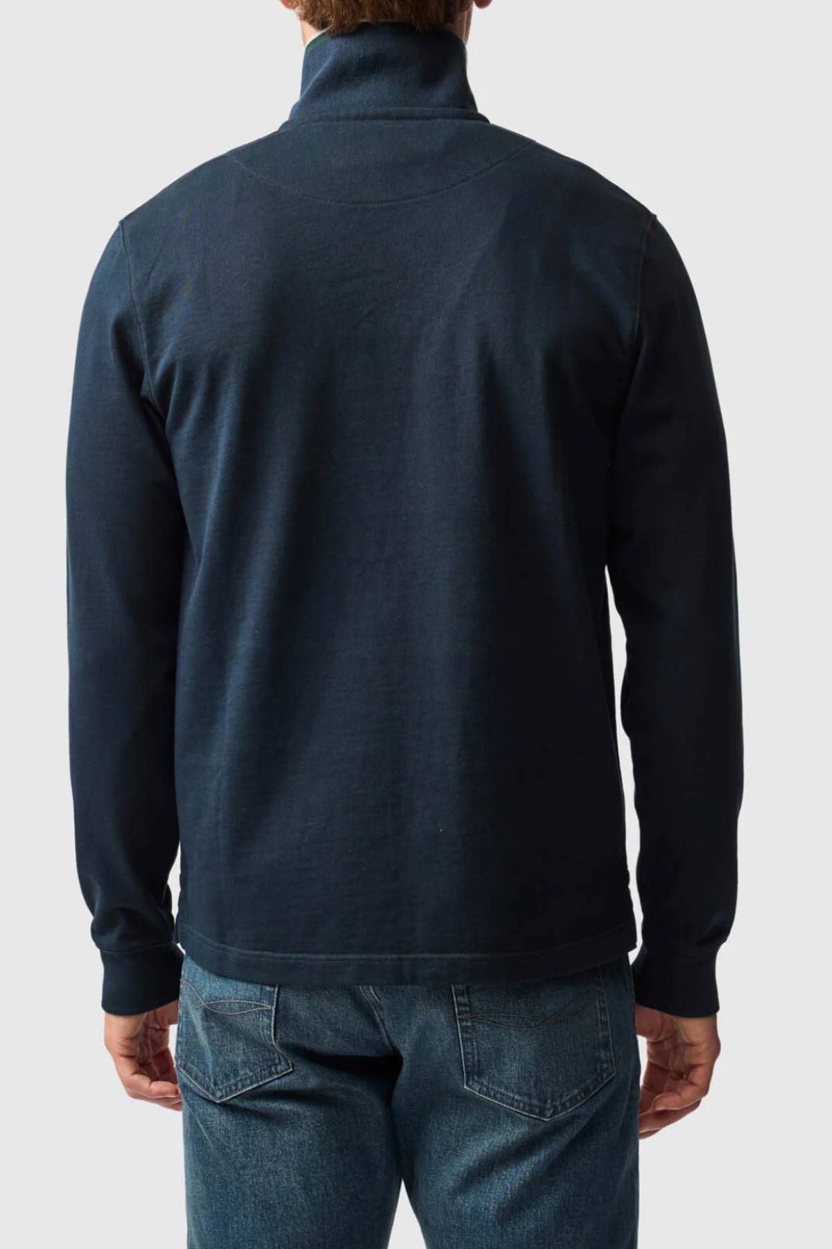 A person is shown from the back against a plain light gray background, wearing a dark blue Rodd & Gunn Gunn 14oz 1/4 Zip Sweat and blue jeans.