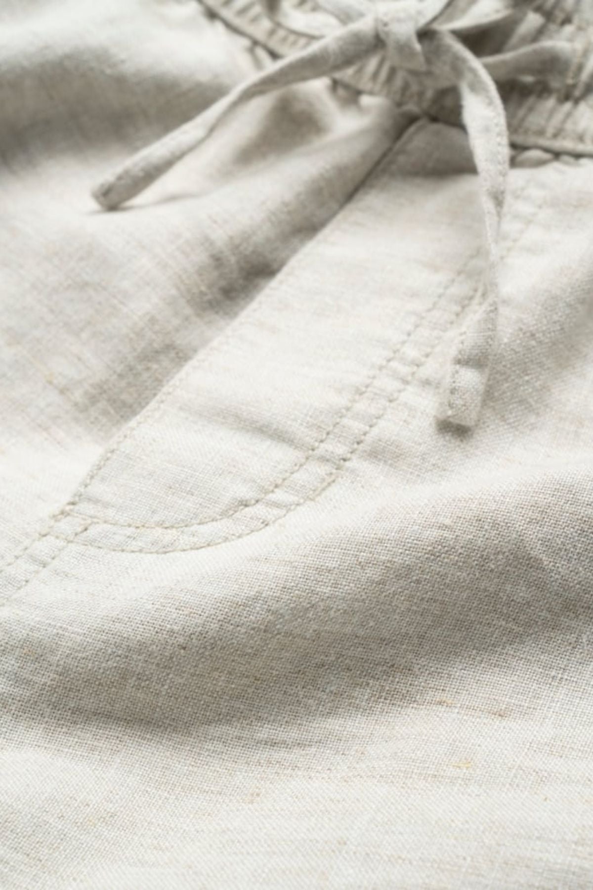 Close-up of the Rodd & Gunn Linen Resort Short in light beige, showcasing a drawstring waistband and a side pocket with visible stitching.