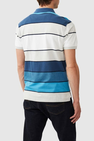 A person wears a Rodd & Gunn McLeod Bay Sports Fit Polo, with blue and white horizontal stripes and a pique texture. Facing away, the shirt's back is highlighted with dark jeans against a light gray background.