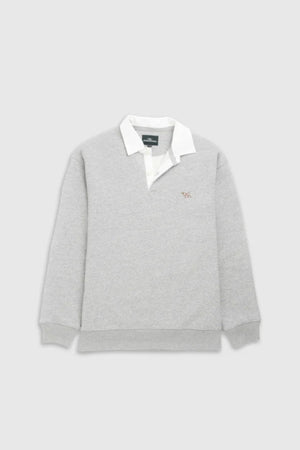 The Rodd & Gunn Otago Sweat is a light gray long-sleeve rugby-style shirt with a traditional twill rugby collar and cuffs, featuring the brand’s signature pointer logo embroidered on the left chest. Displayed on a plain light background.