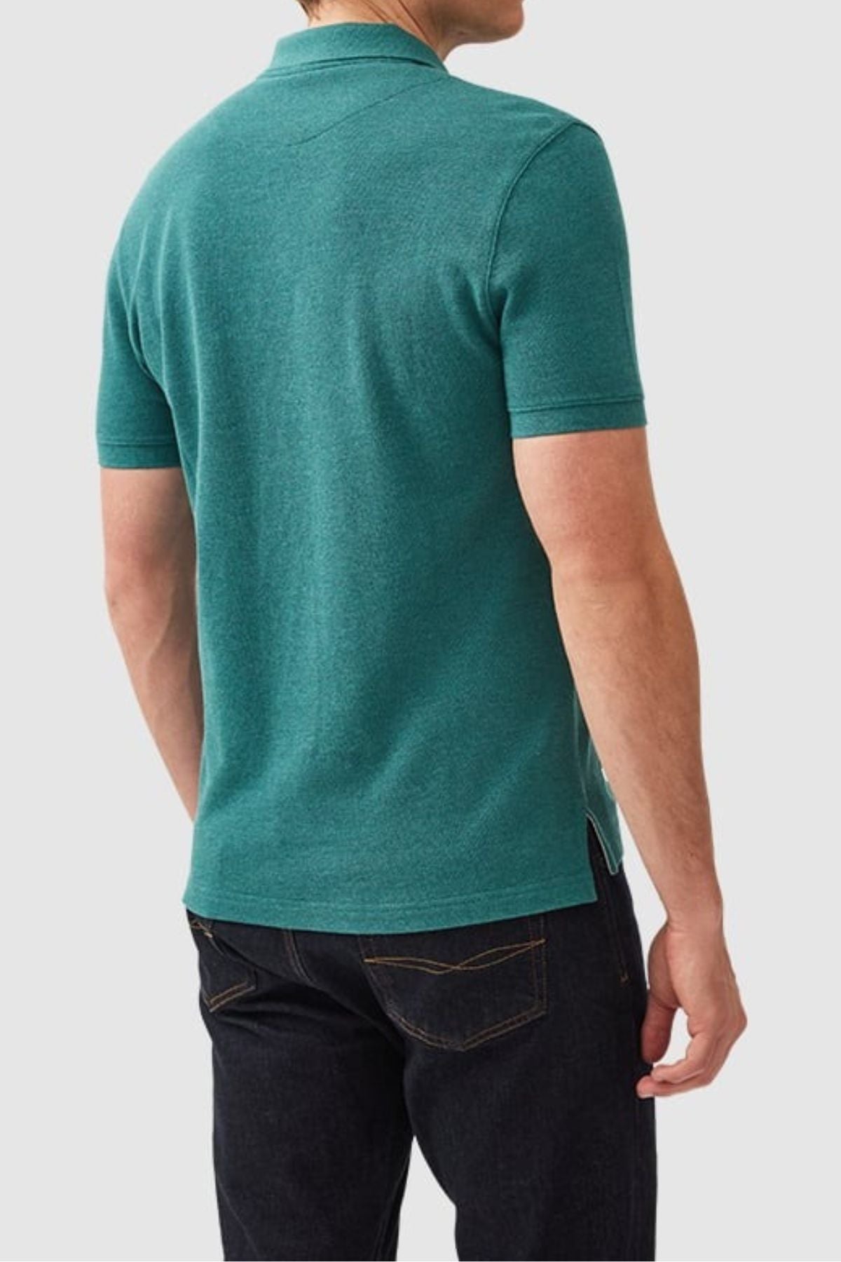 A man faces away, wearing the Rodd & Gunn The Gunn Polo in teal—modern fit, short sleeves, Australian cotton—paired with dark jeans against a plain light gray background.