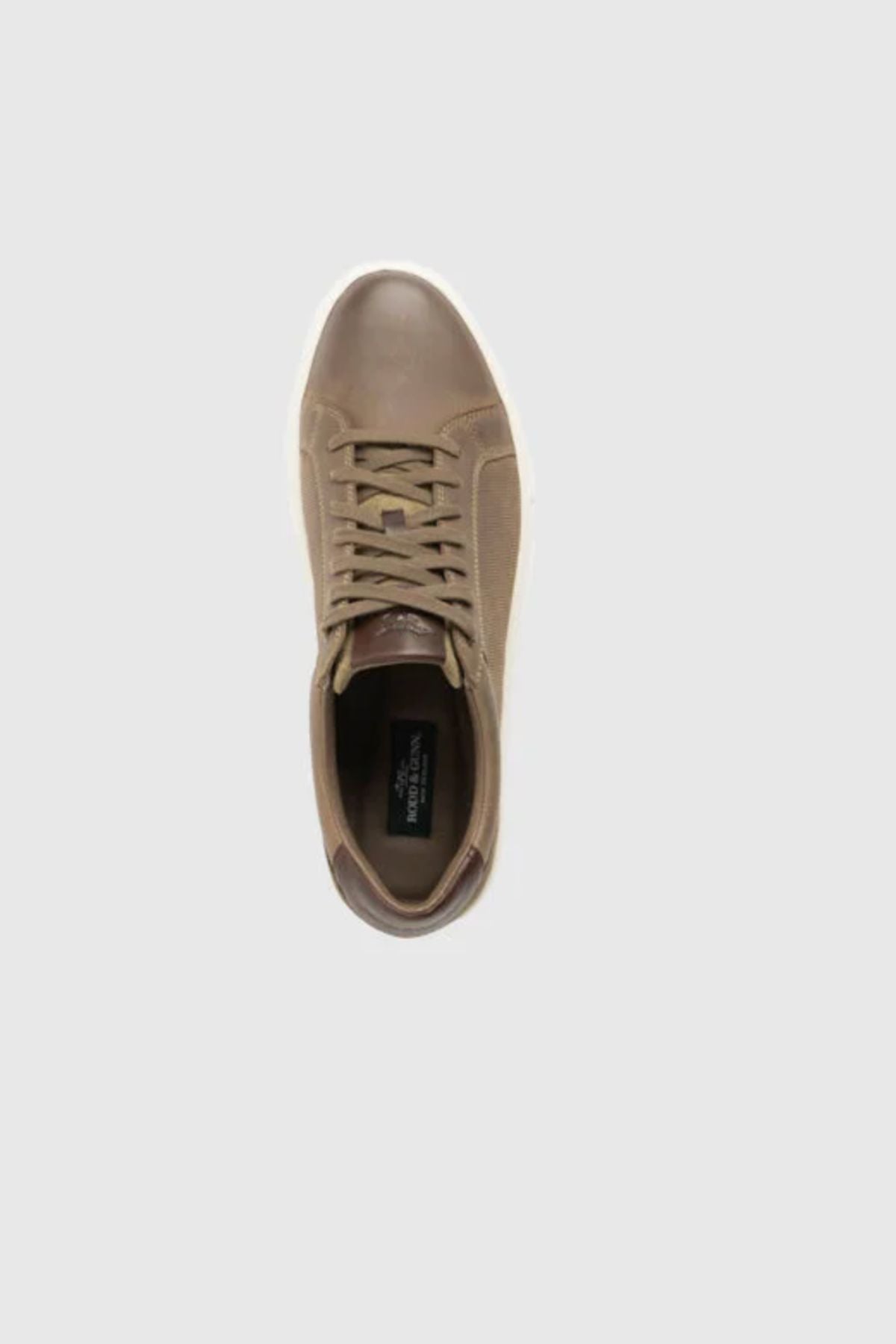 Top view of a single brown Rodd & Gunn Transit Sneaker with a white translucent outsole, shown on a light gray background.