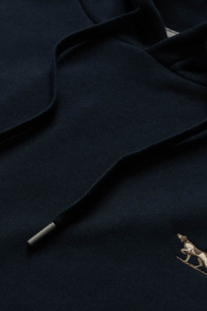 Close-up of the Rodd & Gunn Otago Hoodie, crafted from dark Australian cotton and featuring black drawstrings with a small embroidered dog logo in the lower right corner, highlighting Rodd & Gunn’s signature attention to detail.