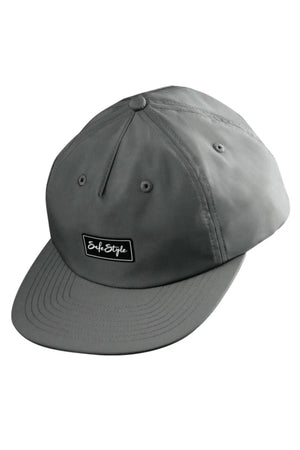 The Safestyle Worksite to Weekend Essentials Cap is a gray baseball cap made from 100% recycled polyester, featuring a curved brim, black "SafeStyle" patch, stitched panels, metal eyelets for ventilation, and quick dry technology for comfort.