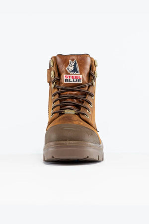 The Steel Blue Argyle Zip Scuff Cap Waterproof Boot is a brown lace-up work boot with a front "Steel Blue" wolf-head logo, metal eyelets, sturdy sole, waterproofing, and Trisole Comfort Technology for all-day support.