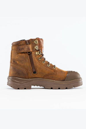 The Steel Blue Argyle Zip Scuff Cap Waterproof Boot, shown on a plain white background, features brown leather, a sturdy rubber sole, Trisole Comfort Technology, metal eyelets, a side zipper, and a protective toe cap.