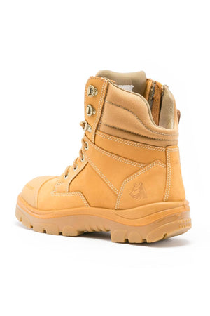 The Steel Blue Southern Cross Zip Boot, a tan high-top with rugged sole, metal eyelets, padded collar, water-resistant leather, safety steel toe, and side zipper, is shown at a slight angle on a white background.