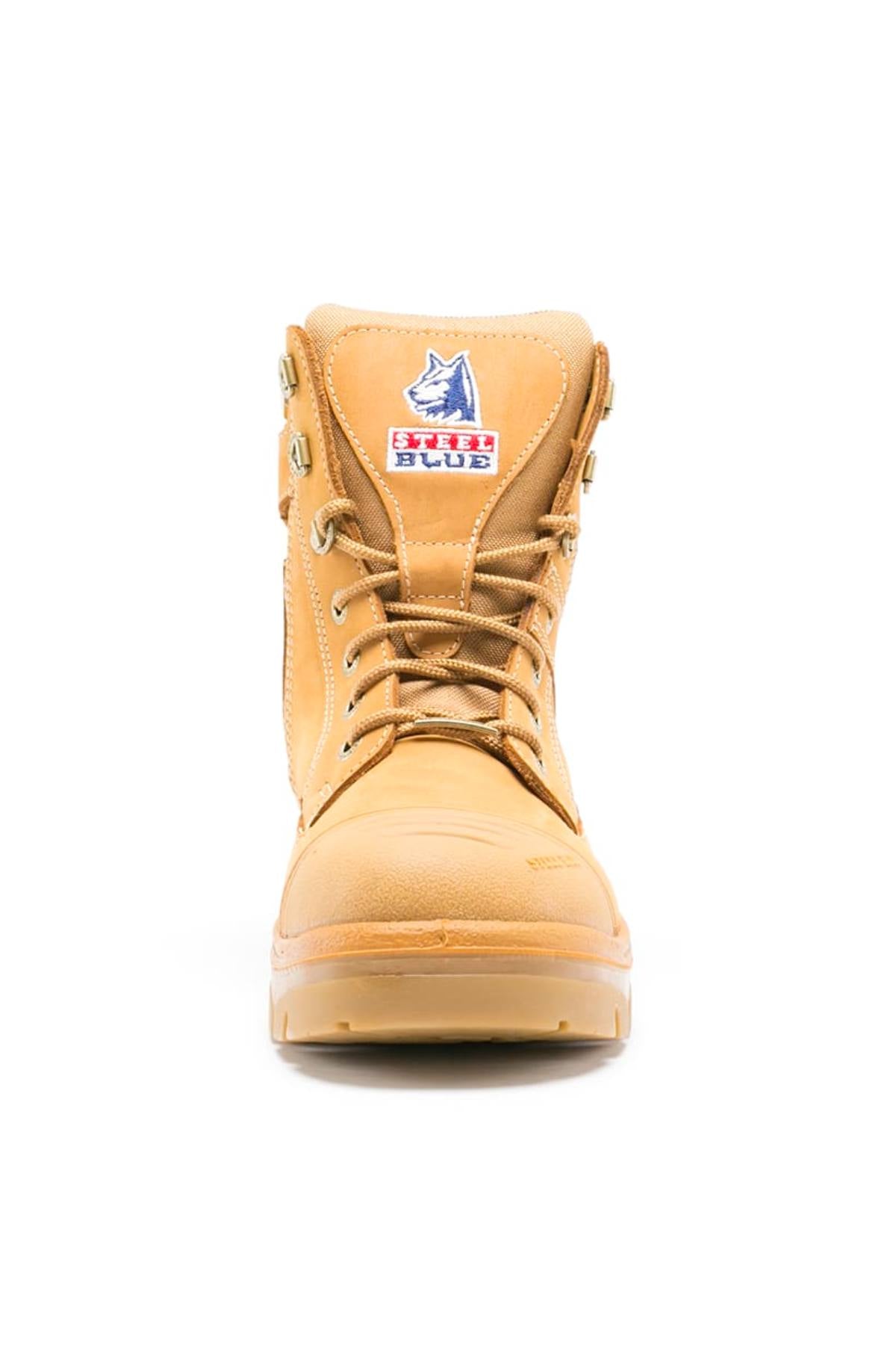 Front view of the Steel Blue Southern Cross Zip Boot in tan with metal eyelets, water-resistant leather, and a wolf logo patch with red text on the tongue, displayed against a white background.